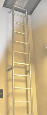 075 An aluminum fixed ladder that leads to an access hatch.