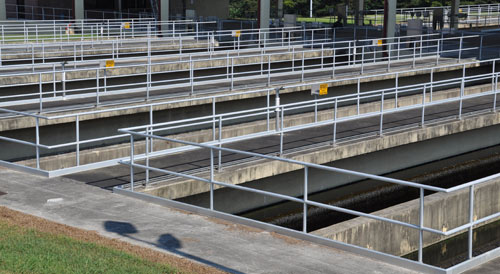 Aluminum handrails surrounding multiple walkways at a wastewater treatment plant.