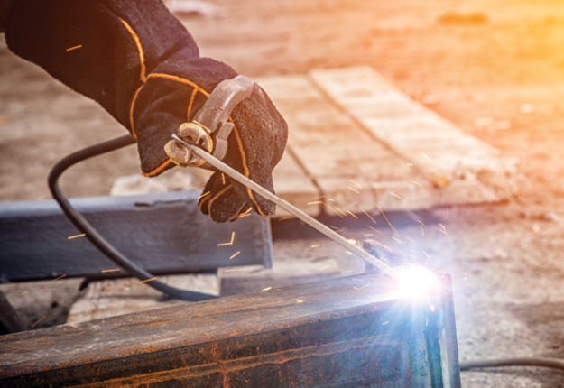 A skilled welder working on a metal box