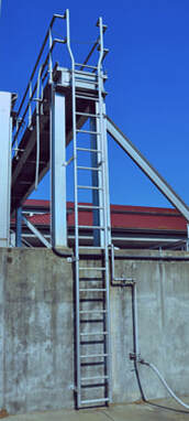 tufladder-product An aluminum industrial ladder the goes into a lowered area at a plant.